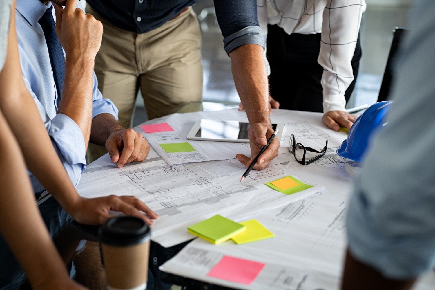 architects-discussing-project-on-blueprint-2026-01-07-06-06-15-utc